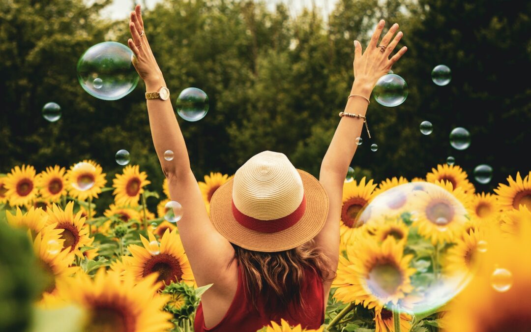 A woman walks through a field of sunflowers to reduce stress.