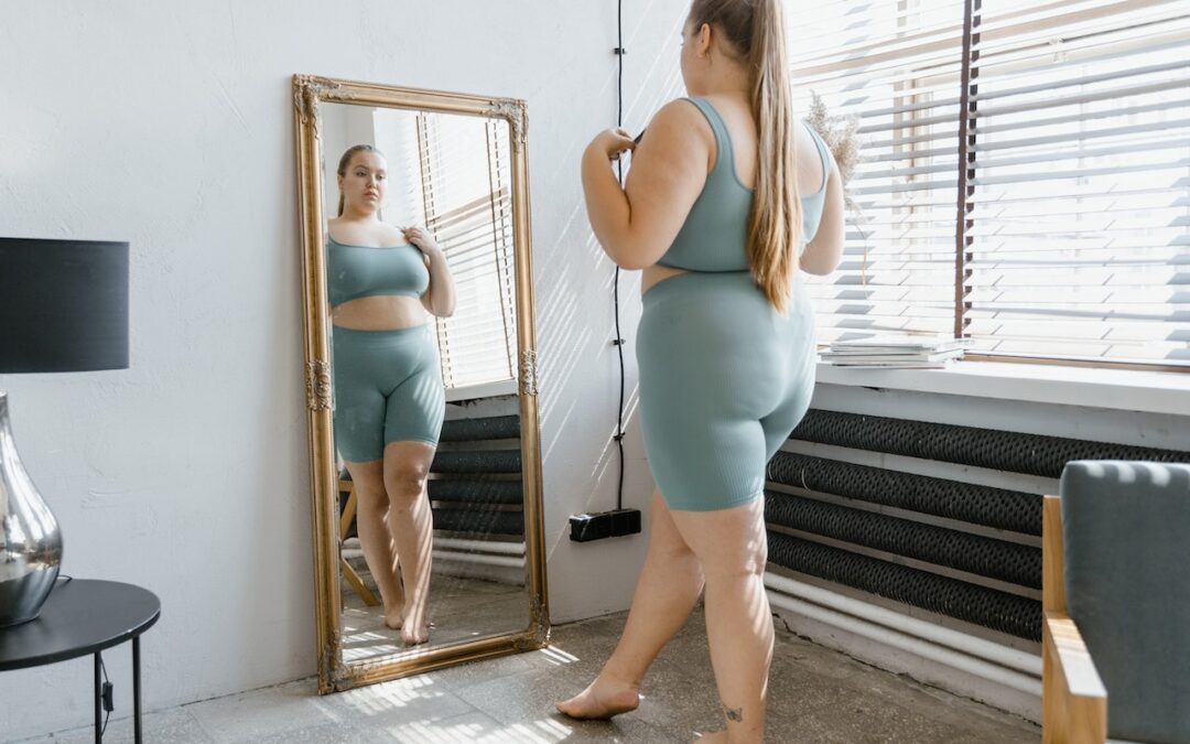 A woman in front of a mirror. Embrace your body like this confident woman.
